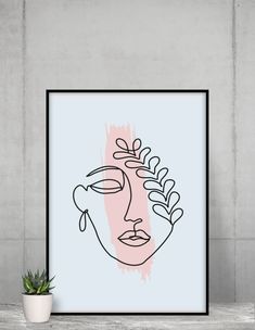 a pink and black abstract face on a blue background next to a potted plant