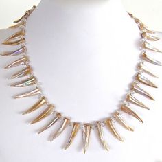 Mother of Pearl Statement Necklace$70.00 Increase your star power with this chic mother of pearl and rock crystal statement piece: https://earthandmoondesign.com/shop/etherea/super-nova-19-inch-mother-of-pearl-statement-necklace/ #GameofThrones inspired- Super Nova, Sideways Initial Necklace, Diamond Bar Necklace, Diamond Choker Necklace, Pearl Statement Necklace, Metalsmithing Jewelry, Dainty Pendant, Cluster Necklace, Handmade Jewelry Designs