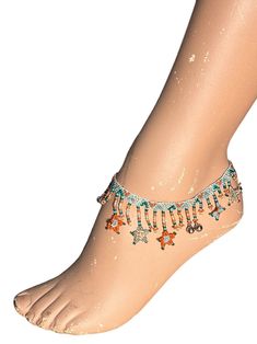 This beautiful Anklet is made entirely with seed beads and features Stars dangling from a patterned band, complimented with tiny bells which have a light jingle. Measuring 10.5 inches in length, this Anklet is adjustable. There are 3 sections to place the button end into.  Each Anklet is made with a mixture of 5 beautiful colours! This one has: Clear Dark Green Frosted Hot Orange Irridescent Turqoise Transparent Peach Smokey Saphire And Silver Tone Bells Festival Adjustable Dangle Anklets, Adjustable Dangle Anklets For Festivals, Festival Anklets With Silver Beads, Colorful Beads Anklet For Festival, Silver Beaded Bracelets For Festival, Bohemian Festive Anklets With Silver Beads, Festive Bohemian Silver Beads Anklets, Bohemian Festival Anklets With Tiny Beads, Multicolor Beaded Anklets For Festivals