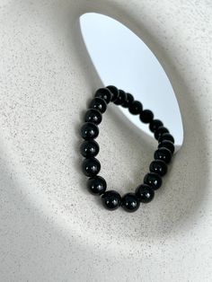 💎 MATERIAL DETAILS ○ 8mm Black Onyx → perseverance, protection, and strength ○ High quality, resistant, and flexible elastic cord (double-corded) 💯 QUALITY & CRAFTSMANSHIP ○ Materials are handpicked, inspected, and handled with the utmost quality and care ○ Double-corded with high quality elastic cord - this means our bracelets have 2x the durability of other stretch bracelets!  ○ Seamless knotting technique which ensures each stretch bracelet knot is concealed ○ Please kindly note natural sto Black Bracelet With 108 Beads, Hand-strung Obsidian Bracelet, Spiritual Black Bracelet With 108 Beads, Black Spiritual Bead Bracelet, Spiritual Black Wristband With Round Beads, Obsidian Round Beads Bracelets For Meditation, Obsidian Round Beads Bracelet For Meditation, Spiritual Beaded Obsidian Bracelets, Adjustable Obsidian Bracelet With Round Beads