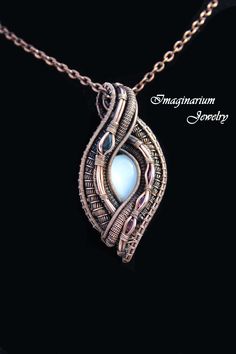 "This spectacular pendant has contributed to the winning of several awards at art festivals. The central stone is a natural white shimmering moonstone and it is accented to the left by a large teardrop blue sapphire and to the right by three sparkling oval pink tourmalines. The pendant is made by creating a frame and then attaching sections of wire that have been wrapped and woven together. It includes a textured 28\" solid copper chain. The copper has been coated with an anti-tarnish sealant to Wire Wrapped Stone Jewelry, Wire Wrap Jewelry Designs, Diy Jewelry Inspiration, Wire Jewelry Designs, Oxidized Copper, Wire Wrapping Stones, Hand Bracelet, White Moonstone, Wire Work Jewelry