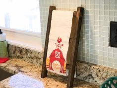 a kitchen counter with a towel rack in the shape of a barn on it's side