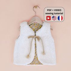 a white vest on a hanger with the text pdf + 1 video sewing tutor