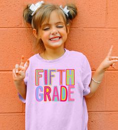 Your little one is sure to love this super cute Back to School Shirt! Perfect for her first day back or meet the teacher! Made with our best selling Comfort Colors brand - now in kids sizes!! Woo hoo! SIZE UP 1-2 SIZES FOR THAT OVERSIZED LOOK   Thanks so much for shopping with me! Please message me with any questions you may have! I am always available to help :) Also, I would love to feature you on our insta if you want to tag me @poppyroseclothing    PRODUCTION TIME: 1-3 business days    SHIPPING TIME: 2-5 business days   PRODUCT DESCRIPTION: Comfort Colors Midweight Tee Created to fit in any kid's active schedule, these kid's tee shirts pack both comfort and agility. Made 100% with combed ring-spun cotton for total comfort whether it's studying or playing time. The fabric is soft-washed Fun Pink T-shirt For School Events, Fun Pink T-shirt For End Of School Year, Cute Letter Print Tops For School Events, Cute Tops With Name Print For Teacher Appreciation, Cute Pink T-shirt For Daycare, Fun Tops For Birthday And Back To School, Pink Shirt For Back To School, Pink Short Sleeve T-shirt For Daycare, Cute Tops For Birthday And Back To School