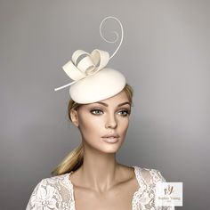 Ivory cocktail hat hand blocked on a button shape wood hat block, made with wool felt and trimmed whith a ostrich spine and a felt bow in Kate Middleton Style. This hat is perfect for winter races, christmas parties, weddings or any special occasion. It is mounted on a elastic . Follow this link for more beautiful choices from 'Sophie Young Hats' https://www.etsy.com/shop/sophieyounghats White Felt Hat With Curved Brim For Party, White Curved Brim Felt Hat For Parties, Elegant White Hat For Gift, Elegant Fascinator With Pinched Crown For Gift, Elegant Pinched Crown Fascinator Gift, Elegant Cream Headpiece For Gift, Elegant Formal Felt Hat, White Fascinator For Kentucky Derby Gift, White Mini Hats For Royal Ascot