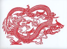 a red paper cut design of a dragon with two heads in the shape of a heart