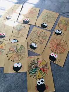 paper bags with spider webs and eyes on them are laid out to make halloween cards