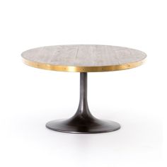 a round table with gold trimmings on the top and an oval metal base