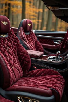 the interior of a car with red velvet seats