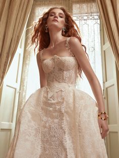 a woman in a wedding dress posing for the camera