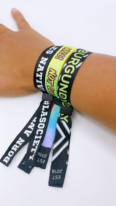 a person's arm with several wristbands on it