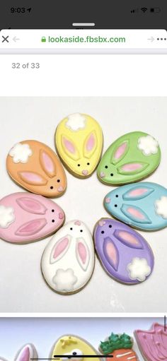 a group of decorated cookies sitting on top of a white table next to each other