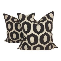 two black and white pillows sitting next to each other