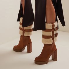 These mid-calf booties feature a comfortable round toe design, lambswool lining for extra comfort, and a chunky heel for stability and a touch of elegance. The rich brown suede exterior exudes a timeless appeal, effortlessly complementing any outfit. Its platform design not only enhances your stature but also provides added comfort for all-day wear. Perfect for cold-weather fashion or a stylish statement piece, these boots are sure to become a beloved staple in your footwear collection. Style: m Winter Knee-high Platform Boots With Lug Sole, Winter High Heel Boots With Stacked Heel, Wide Calf Moto Ankle Boots For Winter, Brown Mid-calf Boots For Winter, Brown Knee-high Boots For Winter, Brown High Ankle Mid-calf Boots For Winter, Winter High Ankle Boots With Stacked Heel, Winter High Ankle Heeled Boots With Stacked Heel, Winter High Heel Mid-calf Boots With Reinforced Heel