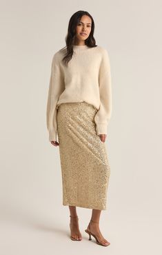 Sparkle all day and night in this sequin midi skirt. Made using our Stretch Sequin fabric, this fully lined, slim fitting elastic pull-on skirt will instantly add eye-catching appeal to your festive wardrobe. Sequin Skirt With Sweater, Skirt With Sweater, Sequin Midi Skirt, Lounge Bra, Comfy Chic, Cozy Chic, Sequin Fabric, Ribbed Neckline, Chunky Sweater