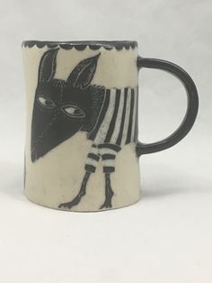 a black and white mug with an animal on it