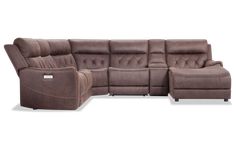 a sectional couch with recliners and ottomans on the back, facing each other