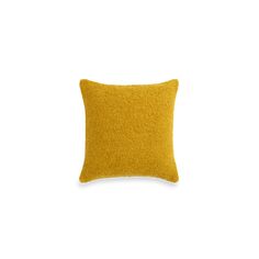 a yellow pillow on a white background