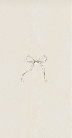 a drawing of a bow on the side of a white wall with writing underneath it