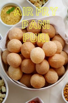 an air fry pani puri is in a bowl with other dishes around it