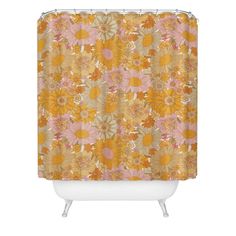 an orange shower curtain with yellow and pink flowers