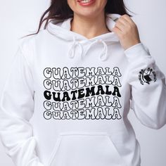 a woman wearing a white hoodie with the words guatemala written in black on it