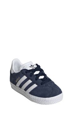 Initially designed in '91 as a training shoe for top athletes, the iconic Gazelle sneaker has been refreshed with stretchy laces for your little athlete. Pull-on style with elastic laces Leather and synthetic upper/textile lining/rubber sole Imported Sporty Non-slip Lace-up Running Shoes, Synthetic Lace-up Skate Shoes With Three Stripes, Non-slip Lace-up Running Shoes For Training, Non-slip Athleisure Sneakers For Sports, Casual Mid-top Skate Shoes For Training, Sporty High-top Sneakers With Elastic Laces, Sporty Lace-up Sneakers With Secure Fit, Adidas Low-top Sneakers For Jogging, Sporty Non-slip Synthetic Skate Shoes