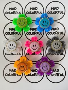 six different colored hair clips with smiley faces on them and the words mad, colorful, mad