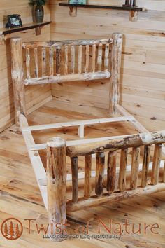 a bed frame made out of wooden logs