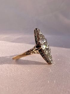 Antique 14k yellow gold rare old European cut diamonds cluster set in a marquise design. There are 21 old mine cut diamonds, with the center stone the largest, gradually decreasing in size as you get closer to the tips of the marquise. This ring is an absolute stunner, and was likely belonged to a woman in the Victorian or Edwardian era (c late 1800s-early 1900s). The shoulder of the band have an ornate etched detailing. Great antique condition Size: 9.25 resizable Weight: 3.5 grams Band: 22.6 m Edwardian Era, European Cut Diamonds, Diamond Cluster, Early 1900s, Cluster Ring, Victorian Era, Druzy Ring, Diamond Cuts, A Woman