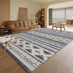 a living room filled with furniture and a large rug