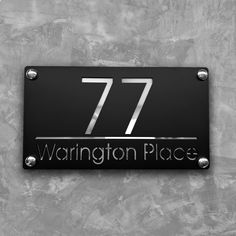 a black and silver sign that says 777 washington places on the side of a wall