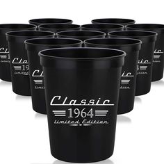 the black plastic cups are lined up together