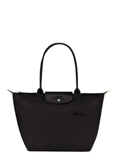 Le Pliage Original L Shoulder Bag by Longchamp captivates you with its minimalist silhouette and ample volume which can easily hold all of your documents or a laptop. Its long handles allow you to wear it comfortably on your shoulder, while its zipper closure ensures the safety of all of your belongings. Longchamp drew its inspiration from origami when creating LE PLIAGE, a light, foldaway bag that has since become a cult object worldwide. The Pliage Green line has an environmentally-friendly st Black Longchamp Bag, Longchamp Bag Le Pliage, Long Champ Bag, Longchamp Le Pliage Neo, Road Trip Bag, Uni Bag, Longchamp Bag, Minimalist Silhouette, Denim Gift