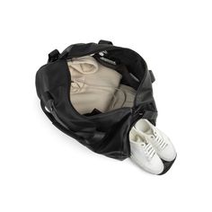 a pair of white tennis shoes sitting in a black duffel bag on a white background