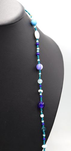 This Necklace with Blue You Away – Blue and White 38” Long Party Necklace by Monkey’s Mojo Southern statement necklace meets the fun and easy wear of light weight and cool glass. Inspired by the fun and festive beads thrown off Mardi Gras floats, this necklace is the perfect touch to complete any outfit. Limited 1 or 1. We couldn’t replicate this necklace if we tired. Materials Used: 11/0 Assorte4d Blue (Teal) and Silver Glass Beads 8/0 Assorted Aqua, Blue, and White Beads 6.5mm/8.4mm White Glas Blue Single Strand Long Beaded Necklace, Blue Long Single Strand Beaded Necklace, Blue Long Necklace Suitable As A Gift, Blue Glass Beaded Necklaces For Party, Blue Beaded Chain Necklace For Party, Light Blue Round Bead Necklaces For Party, Blue Glass Beaded Bohemian Necklace, Blue Beaded Chain Bohemian Necklace, Light Blue Beaded Necklaces For Party