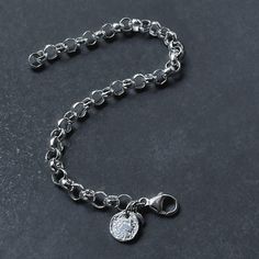 Enhance your style with this elegant sterling silver rolo tag bracelet. Boasting a 6.3mm belcher bracelet and classic design, this bracelet is minimal yet bold. Perfectly paired with a reticulated round tag, this bracelet will add a touch of sophistication to any look. Details: Chain: Sterling Silver Rolo Chain, 6.3mm Clasp: Sterling Silver Lobster claw clasp Sizes: 6" to 9” Full and half sizes Shipping: Ready to ship within one business day Complimentary shipping in the USA Complimentary gift w Silver Bracelets With Coin Pendant As Gift, Silver Bracelets With Coin Pendant For Gift, Silver Charms Chain Bracelet For Everyday, Nickel-free White Gold Charm Bracelet, Everyday Silver Coin Jewelry, Charm Chain Bracelet, Chunky Bracelet, Coin Bracelet, Round Tags