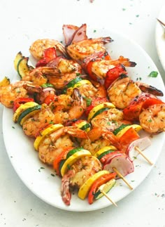 grilled shrimp and vegetable kabobs on a white plate