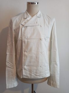 Deadstock vintage Swedish white cotton utility / cook's jacket. Dated 1992. Classic double breasted cook's services style with white buttons. 100% cotton, three crown Swedish military label marked D104.  Please check the measurements below. Deadstock and unlaundered.  Not musty.  Some minor storage wear and minor storage marks. Creased all over from storage and will need to be laundered before wear in any case to remove the dressing.  Priced accordingly. 18 3/4" across the shoulders Sleeves are White Double-breasted Button-up Outerwear, White Double-breasted Outerwear, Chore Jacket, Dress Codes, Shoulder Sleeve, Shopping List, White Vintage, White Cotton, Chef's Jackets