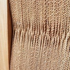 close up view of the textured fabric on a wooden frame with wood slats