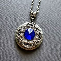 Vintage Locket Swarovski Crystal Necklace Royal Blue Regal ☻Locket ~ Antique Silver ~ Tarnish Resistant ☻Crystal ~ Genuine Swarovski Crystal Chain: ~ Silver Plated YOU CHOOSE YOUR CHAIN LENGTH during checkout ☻Link To More Color Choices in This Style Locket: https://www.etsy.com/shop/FashionCrashJewelry?ref=simple-shop-header-name&listing_id=883624621&search_query=crystal+locket ☻Link to The ENTIRE SHOP: https://www.etsy.com/shop/FashionCrashJewelry?ref=shopsection_shophome_leftnav&g Blue Round Pendant Jewelry With Chain, Blue Jewelry With Chain And Round Pendant, Blue Round Pendant Chain Jewelry, Blue Jewelry With Round Pendant Chain, Blue Medallion Jewelry With Adjustable Chain, Formal Blue Locket Jewelry, Blue Medallion Necklace For Wedding, Blue Medallion Necklaces For Wedding, Vintage Blue Jewelry With Chain