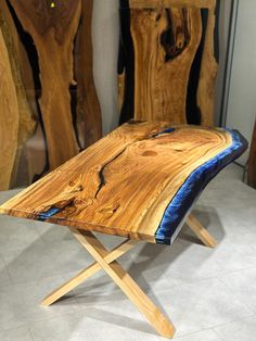 a wooden bench sitting on top of a white tile floor next to wood pieces in the background