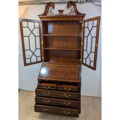 an antique wooden desk with three drawers