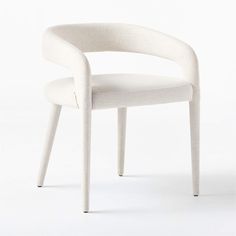 a white chair sitting on top of a white floor