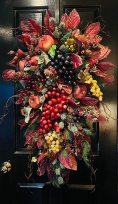 a door decorated with autumn leaves and berries