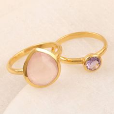 Designed with pink and purple jewels, Neetu Barathi's feminine pair of stacking rings look great together or apart. Indian artisans use 18k gold-plated sterling silver to hand craft the pair, centering one with faceted amethyst, the other with faceted rose quartz. Pink Amethyst Rings For Gift, Pink Amethyst Ring With Gemstone Accents As Gift, Gold Stackable Rings With Gemstone Accents For Gift, Gold Stackable Rings With Gemstone Accents As A Gift, Pink Stackable Rings With Ethical Gemstones As Gift, Adjustable Pink Gemstone Stackable Rings, Gemstone Stacking Ring, Amethyst Color, Hand Craft