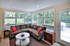 a living room filled with furniture and lots of windows