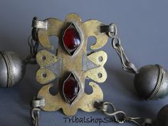 Vintage Turkmen goldwashed metal tribal ring with bells and two red glass jewels in eyeshaped settings to protect the wearer from the evil eye.  The face shows goldwash. This ring is app. 30 - 60 years old and a very rare piece of tribal jewelry. It is in an very good condition with some patina. Size 19 mm inside diameter, US Size 9, Weigth 26 gFor the whole choice of old tribal rings, here is my ring-section: https://www.etsy.com/de/shop/TribalshopSalome?ref=simple-shop-header-name&listing_ Festival Metal Bells Jewelry, Traditional Bronze Decorative Jewelry, Traditional Decorative Bronze Jewelry, Red Band, Silk Road, My Heritage, Red Glass, Metal Beads, Very Rare