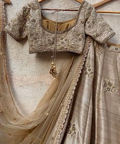 Features a vintage gold raw silk lehenga hand embellished with sequins, pearl and cutdana buttis and a zari and pearl work border. Paired with a matching raw silk blouse hand embroidered with zardozi, sequin and pearl work and a matching sequinned net dupatta Composition : Lehenga and Blouse - Raw Silk, Dupatta - Soft Net All products can be customised for sleeves, length of blouse and neck design Delivery : 2-4 weeks as the product is hand crafted. Check Size Guide or choose MySize for free customisation (All Sizes above XL can be made at 15% additional cost) For more information and sizes please contact fabiliciousfashion@gmail.com or visit our Copenhagen studio.About the Designer : Priti Sahni started out with a career on the well-trodden path by following typical Indian parent’s goal, Raw Silk Blouse, Banarasi Lehenga, Raw Silk Lehenga, Tan Blouse, Zardosi Work, Pearl Work, Travel Infographic, Lehenga Designs Simple, Bridal Lehenga Collection