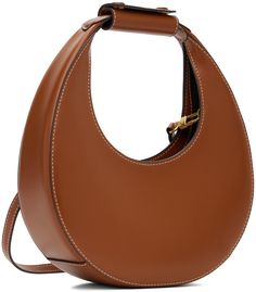 Polished leather shoulder bag in tan. · Press-stud tab at integrated carry handle · Adjustable and detachable crossbody strap · Magnetic press-stud tab closure · Zip pocket at interior · Suede lining · Contrast stitching in off-white · H4.75 x W9 x D3 · Total height: H10.5 Supplier color: Tan Brown Bags With Round Handle For Work, Brown Bags With Round Handle For Workwear, Brown Workwear Bags With Round Handle, Staud Top Handle Bag For Everyday, Staud Tote Shoulder Bag For Everyday, Staud Satchel Shoulder Bag For Everyday Use, Everyday Staud Bags With Detachable Strap, Brown Office Bag With Round Handle, Staud Crossbody Bag For Everyday Use